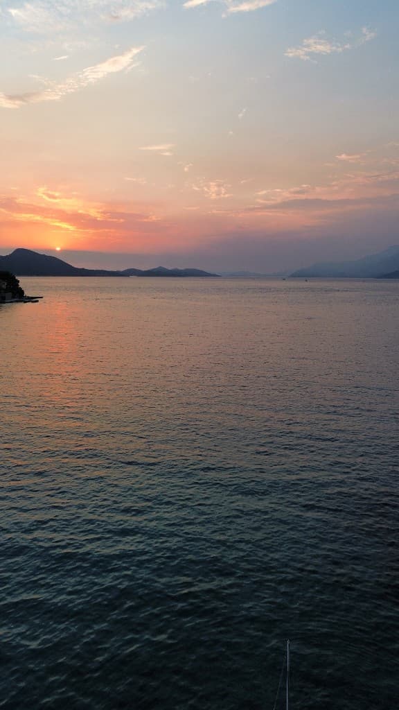 Sunset boat tour with islands on the horizon