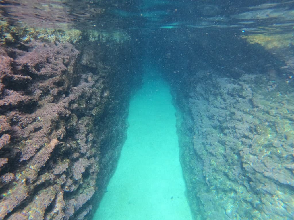 Underwater snorkeling passage with sandy bottom